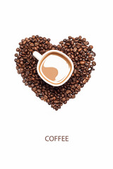 Cup of coffee surrounded by coffee beans in shape of heart on white background