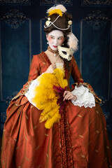 18th-Century woman wearing a silk robe a la Francaise and holding a large ostrich feather fan 