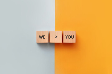 Wooden cubes with the inscription: us and you. An image of a society that is more than an individual