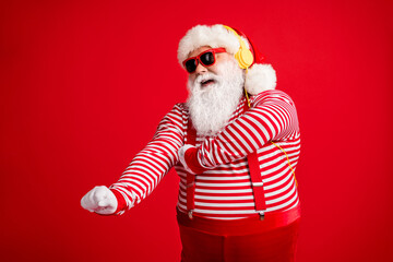 Portrait of his he handsome bearded fat overweight cheerful cheery dreamy Santa fan meloman listening single sound dancing having fun isolated bright vivid shine vibrant red color background