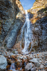 Fototapeta na wymiar Caucasian mountain landscape. Waterfall in Tsey gorge. Republic of North Ossetia-Alania, Russia