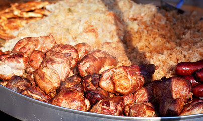 Grilled pork meat and cabbage - traditional Slovak street food - prepared on street, closeup detail