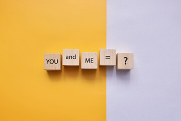 Wooden cubes with the inscription: you and I are equal to a question mark. Misunderstood relationships between people