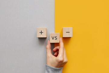 Wooden cubes with the image of pros versus cons. cons and pros in a person's life - obrazy, fototapety, plakaty