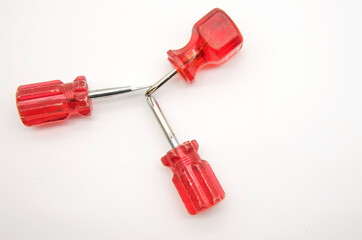 Three small screwdrivers with red handles on a white background.