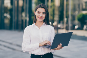 Photo of cute charming young woman assistant wear white formal shirt typing modern device outdoors