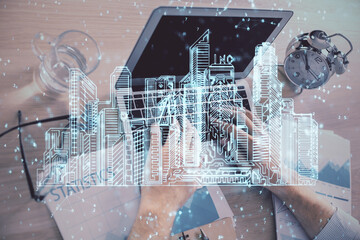 High tech city drawing with businessman working on computer on background. Smartcity concept. Double exposure.