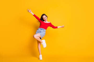 Full length body photo portrait of oretty crazy cheerful lovely nice glad positive optimistic lady having fun time isolated over bright color yellow background
