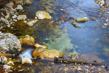 Water splash on a river with small cascades.