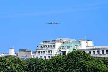 The plane flies low over the houses of Paris, France