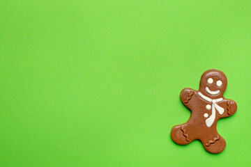 Chocolate figurine of a gingerbread man on a green background new year and Christmas holidays with copyspace