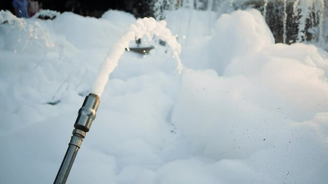 Huge amount of foam in the fountain. The prankster added shampoo to the fountain. Washing the fountain
