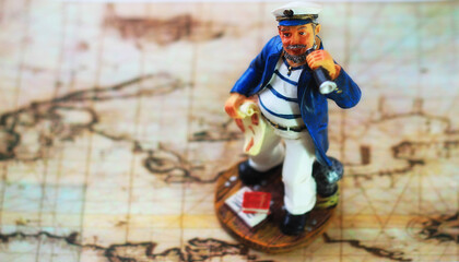 Fototapeta na wymiar Small sailor on the world map.