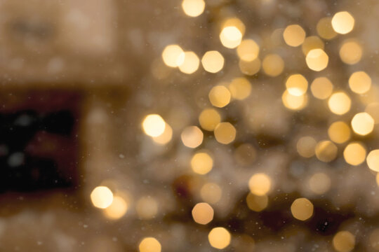 Abstract Christmas background with blurred Christmas tree and lights on back. Boken effect. Disfocus image.