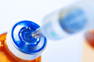 Medical vial with medication and syringe close up