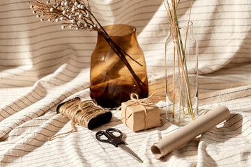 packing and decoration concept - still life of gift box, craft wrapping paper, rope and scissors...