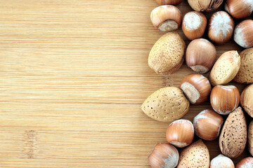 Walnuts and other nuts on a wooden board.