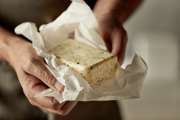 Chef holding a pat of farm fresh herb butter
