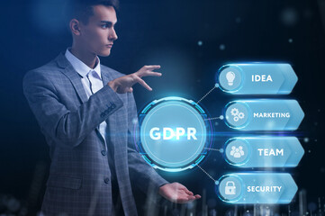 Business, Technology, Internet and network concept. Young businessman working on a virtual screen of the future and sees the inscription: GDPR