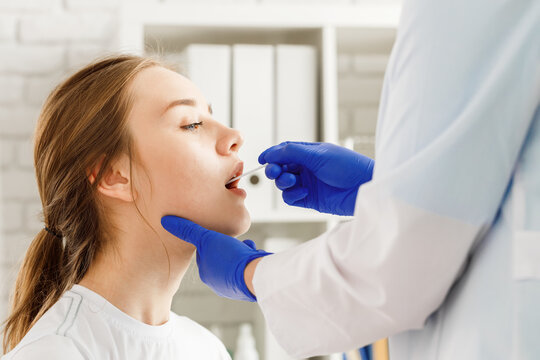 Doctor taking a throat swab from a patient woman