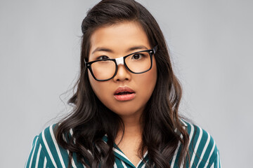 people, education and school concept - portrait of confused asian woman in broken glasses with...