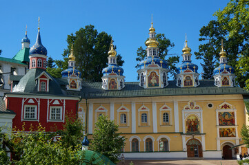 Fototapeta na wymiar Holy Dormition Pskov-Pechersky Monastery. Domes of the Intercession Church, built over the Assumption cave temple