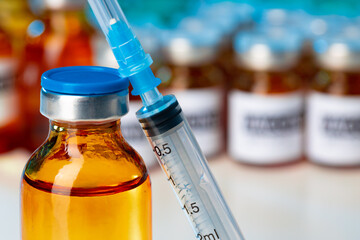 Medical vial with medication and syringe close up