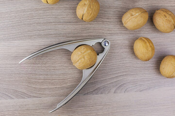 Whole walnuts in shell in bowl, walnut kernels. Top view.