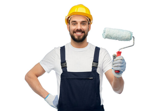 profession, construction and building - happy smiling male worker or builder in yellow helmet and overall with paint roller over white background