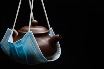 image of teapot mask dark background 