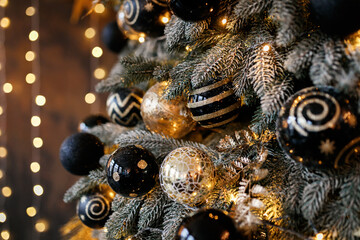 Beautiful festive Christmas tree is in the room decorated with Christmas toys balls