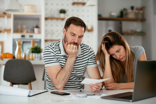 Husband and wife preparing bills to pay. Young couple having financial problems.