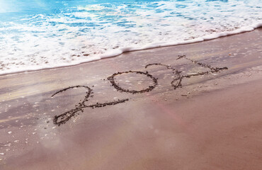 Happy New Year 2021 text on the beach