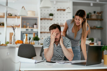 Husband and wife preparing bills to pay. Young couple having financial problems.