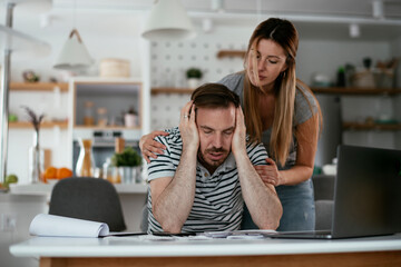 Husband and wife preparing bills to pay. Young couple having financial problems.