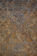 wooden door in the alhambra decorated with mosaic