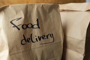 Craft packages with food delivery on dark wooden background
