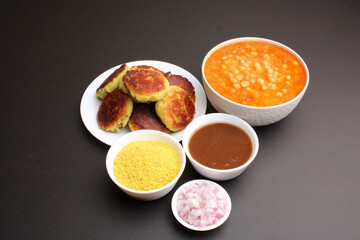 Fototapeta na wymiar Ragda pattice -Aloo tikki or Potato Cutlet or Patties is a popular Indian street food made with boiled potatoes, spices and herbs served with tamrind chutney and peas curry.