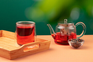Glass teapot and cup with black tea