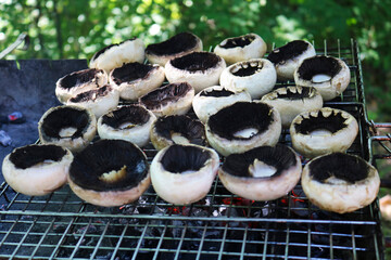 Cooking mushrooms on the grill. Champignon white mushrooms grilled on grill or BBQ