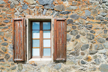 Aged window on a wall made of stones. With copy space