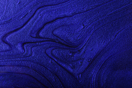 Fototapeta Horizontal navy blue shimmer abstract background. Make up concept.Beautiful stains of liquid nail laquers.Fluid art,pour painting technique.Horizontal banner,can be used as backdrop for chat.