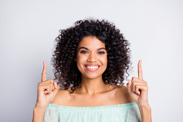 Photo portrait of woman pointing two fingers up at blank space isolated on white colored background