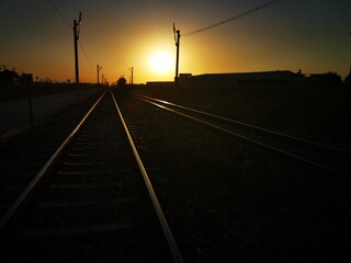 Fototapeta na wymiar shiny railway tracks glowing in the golden light of sunset showing excellent perspective Tarsus Turkey