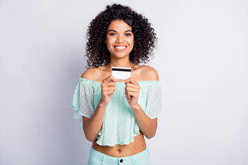 Photo portrait of smiling woman holding plastic card in two hands isolated on white colored background