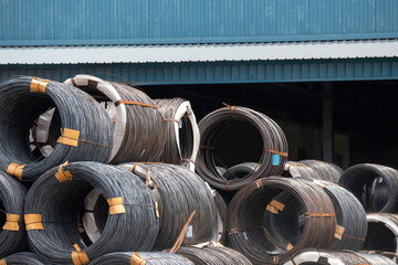 metal wire rod on outdoor storage yard of factory. stacked rusty metal coils.