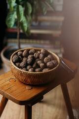 walnuts in wooden bowl on the wooden chair