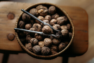 walnuts in the wooden bowl with walnut opener