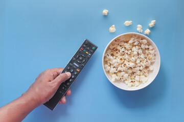 high angle view of popcorn and Tv remote on table 