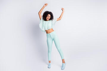 Full length body size photo of happy pretty black skinned girl wearing mint clothes dancing isolated on grey color background